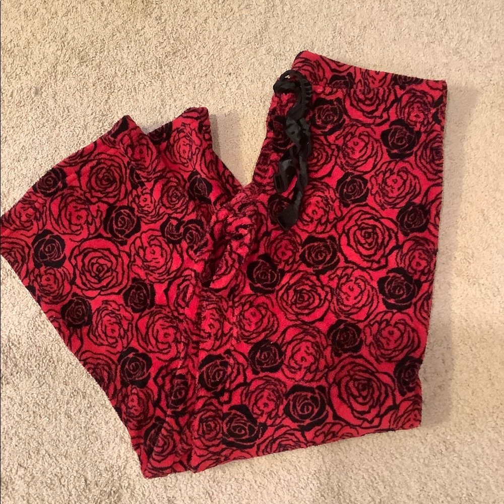 Warm and fuzzy red pajama pants with black roses